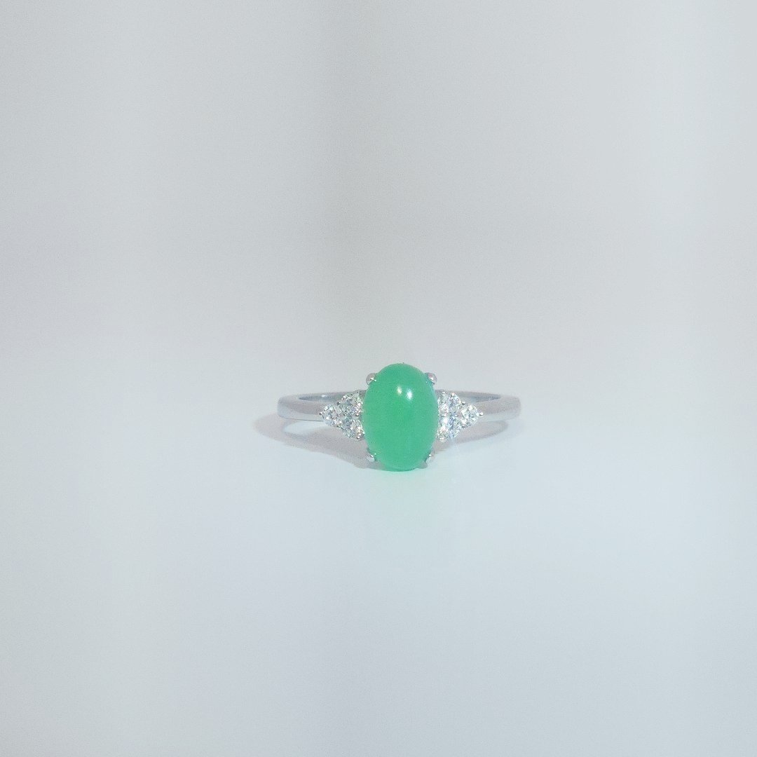 Women's Sterling Silver Ring with oval cabochon Jade center stone flanked by small white accent stones, size 7.