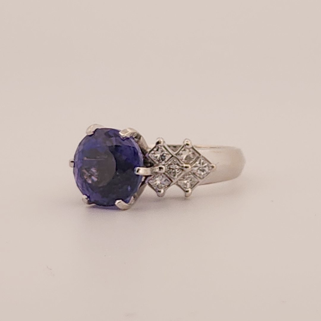 Natural Round Modified Brilliant Cut, Bluish Violet Tanzanite (5.25 CT - 10.20 mm) with 12 Natural Princess cut 3x3 mm Square Diamonds (1.92 CTW) Ring 14K White Gold. GIA Certified (2231466864).